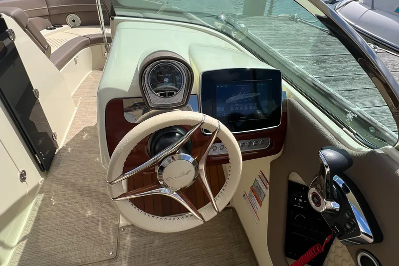 Slide: The Image of 2023 Chris-Craft Launch 28 GT dashboard with steering wheel and digital display. - 26