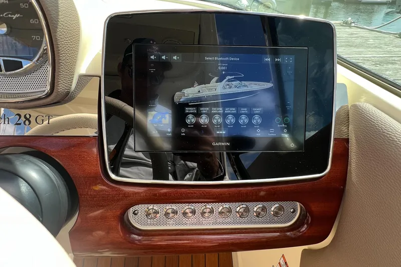 Slide: The Image of 2023 Chris-Craft Launch 28 GT dashboard with touchscreen display and controls. - 27