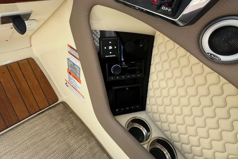 Slide: The Image of 2023 Chris-Craft Launch 28 GT interior dashboard with controls and speaker. - 28