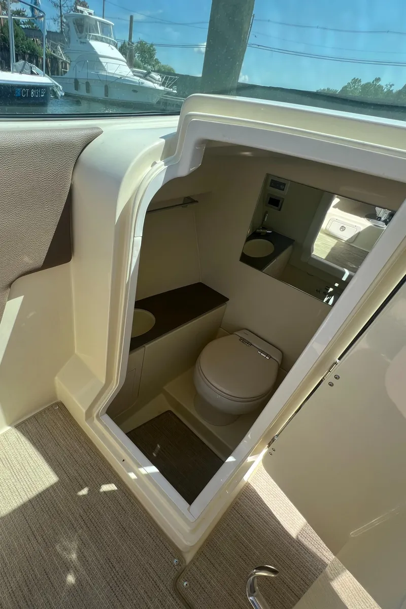 Slide: The Image of 2023 Chris-Craft Launch 28 GT boat interior with compact bathroom. - 30