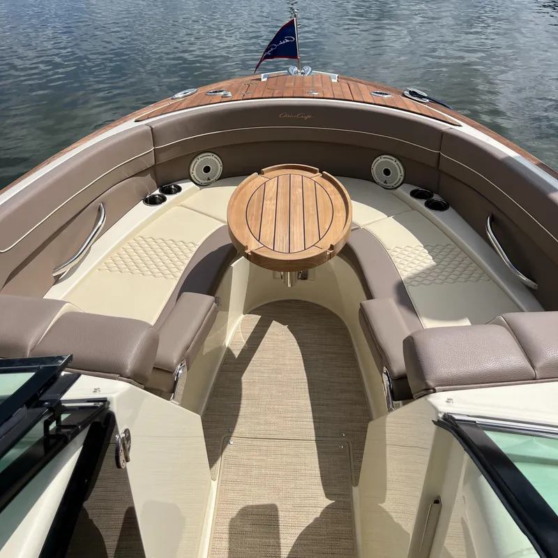 Slide: The Image of 2023 Chris-Craft Launch 28 GT boat interior with elegant seating and wooden table. - 37