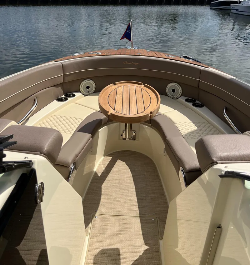 Slide: The Image of 2023 Chris-Craft Launch 28 GT boat interior with seating and wooden table. - 38