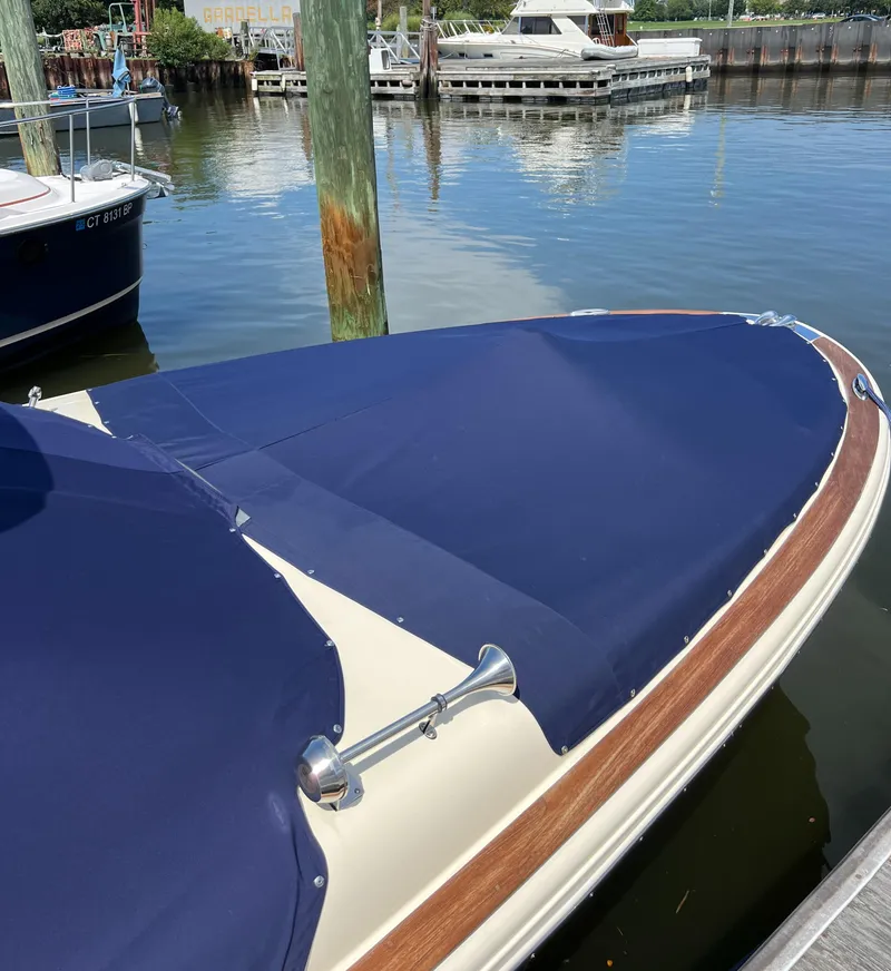 Slide: The Image of 2023 Chris-Craft Launch 28 GT boat with blue cover docked at marina. - 4