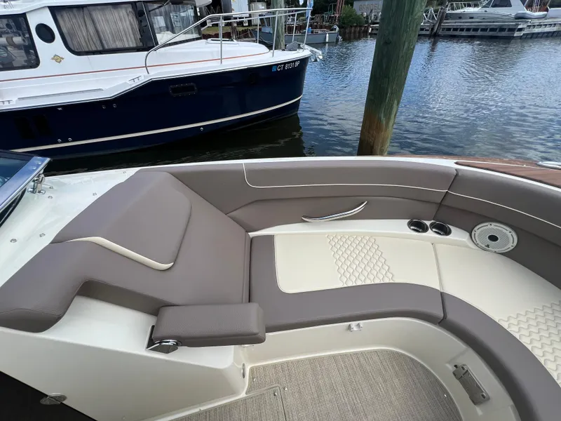 Slide: The Image of 2023 Chris-Craft Launch 28 GT boat interior with elegant seating by the water. - 43