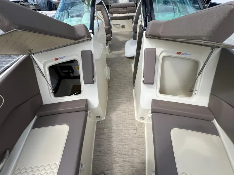 Slide: The Image of 2023 Chris-Craft Launch 28 GT interior with beige and brown seating, open storage compartments. - 45
