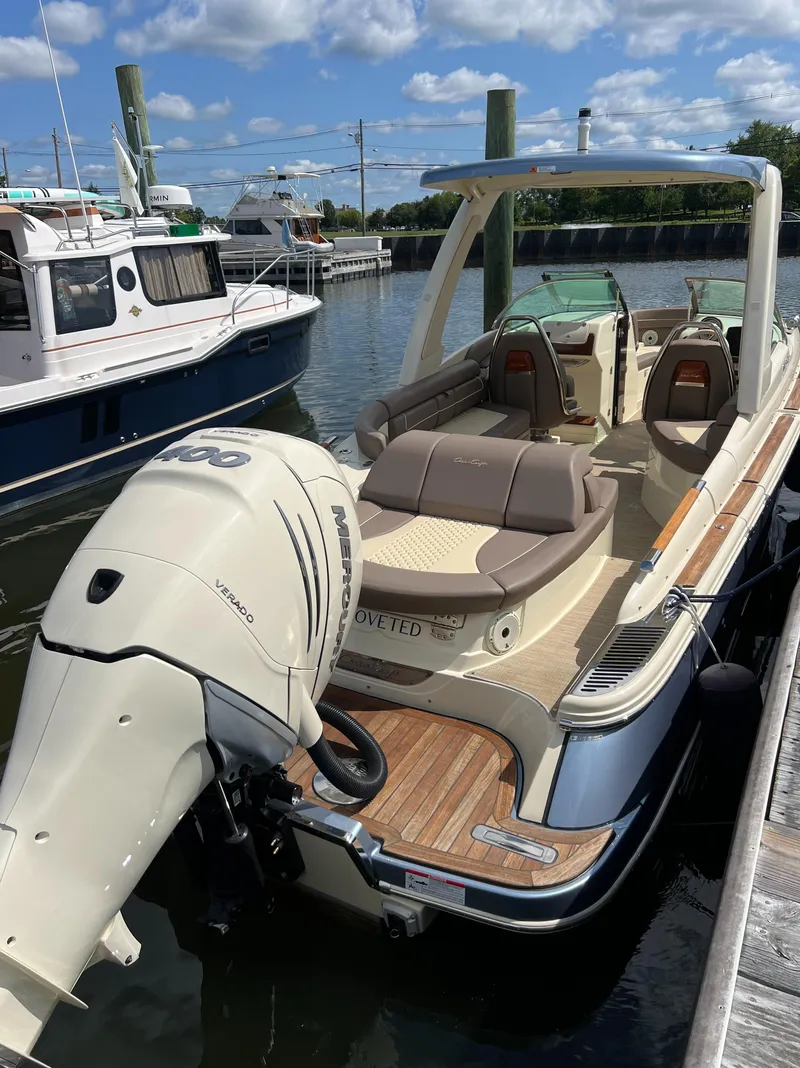 Slide: The Image of 2023 Chris-Craft Launch 28 GT boat docked in marina under blue sky. - 8