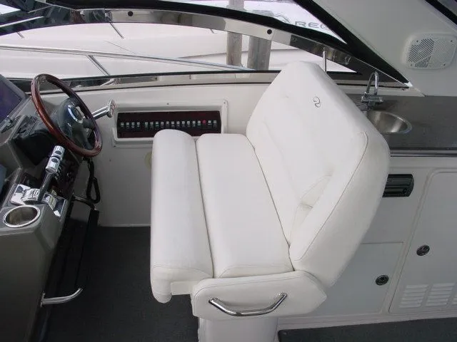 Slide: The Image of 2007 Regal 4460 Commodore helm with white seating and control panel. - 10
