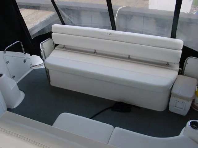 Slide: The Image of 2007 Regal 4460 Commodore boat interior with white seating and carpeted floor. - 11