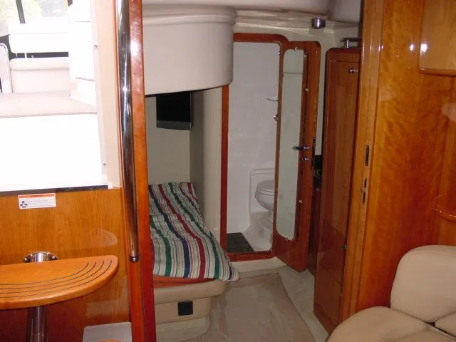 Slide: The Image of Interior of 2007 Regal 4460 Commodore yacht with cozy cabin and wooden finishes. - 13