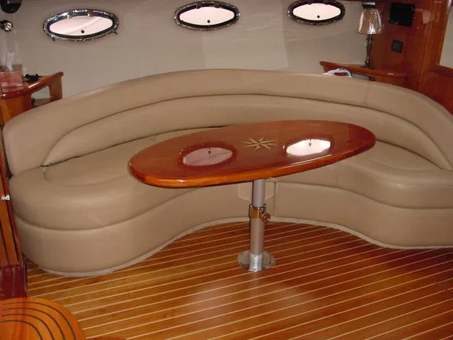 Slide: The Image of Luxurious interior of 2007 Regal 4460 Commodore yacht with curved seating and wooden table. - 15