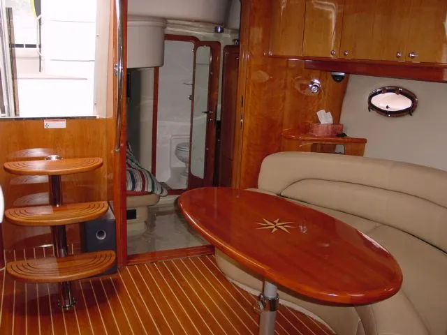 Slide: The Image of Luxurious interior of 2007 Regal 4460 Commodore yacht with wooden finishes and cozy seating. - 19