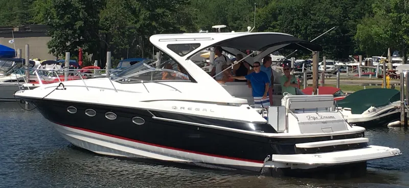 Slide: The Image of 2007 Regal 4460 Commodore yacht docked at a marina, featuring sleek design and modern amenities. - 2