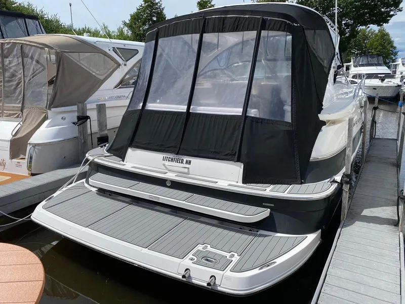 Slide: The Image of 2007 Regal 4460 Commodore yacht docked, featuring a covered rear deck. - 20
