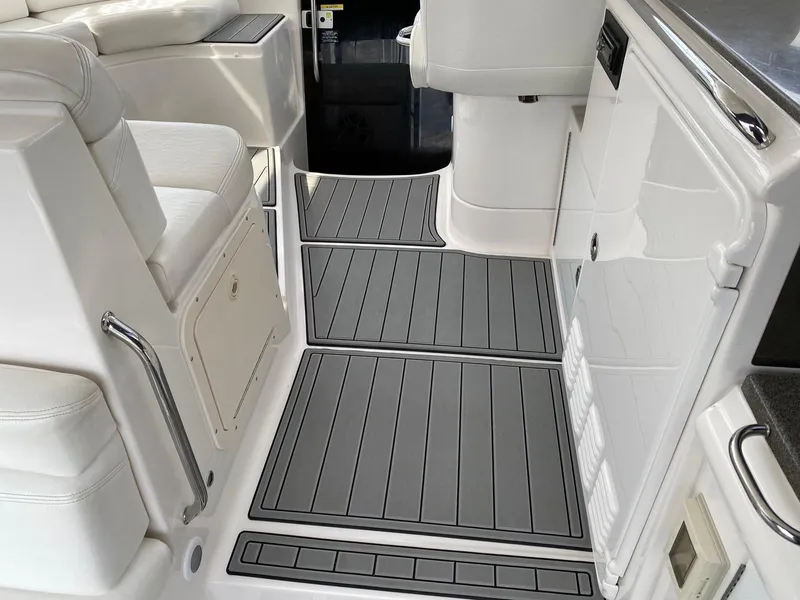 Slide: The Image of 2007 Regal 4460 Commodore interior with sleek white seating and gray flooring. - 21