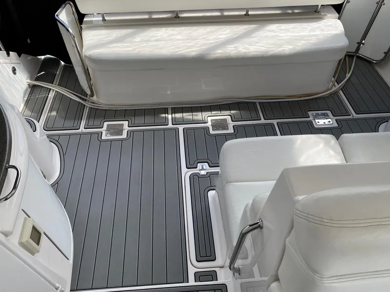 Slide: The Image of 2007 Regal 4460 Commodore boat interior with sleek seating and modern flooring. - 23