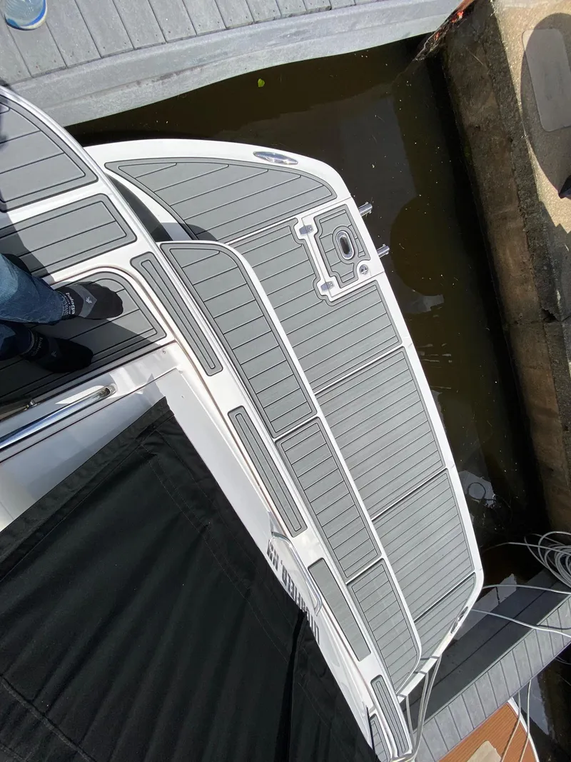 Slide: The Image of 2007 Regal 4460 Commodore boat docked, featuring a sleek, modern deck design. - 24