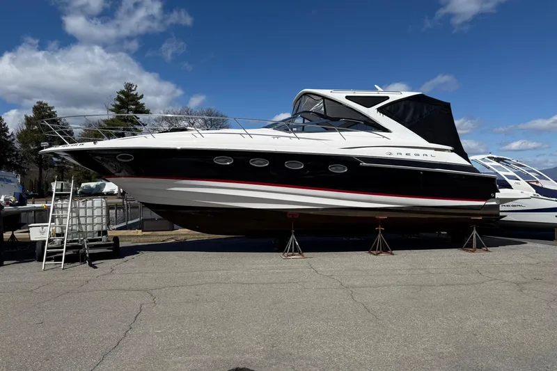Slide: The Image of 2007 Regal Commodore 4460 yacht on stands under a clear blue sky. - 27