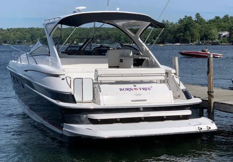 Slide: The Image of 2007 Regal 4460 Commodore yacht docked on a serene lake. - 3