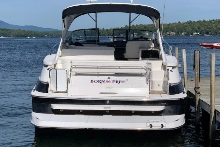 Slide: The Image of 2007 Regal 4460 Commodore boat docked on a serene lake. - 4