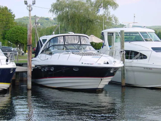 Slide: The Image of 2007 Regal 4460 Commodore yacht docked at marina, surrounded by water and greenery. - 5