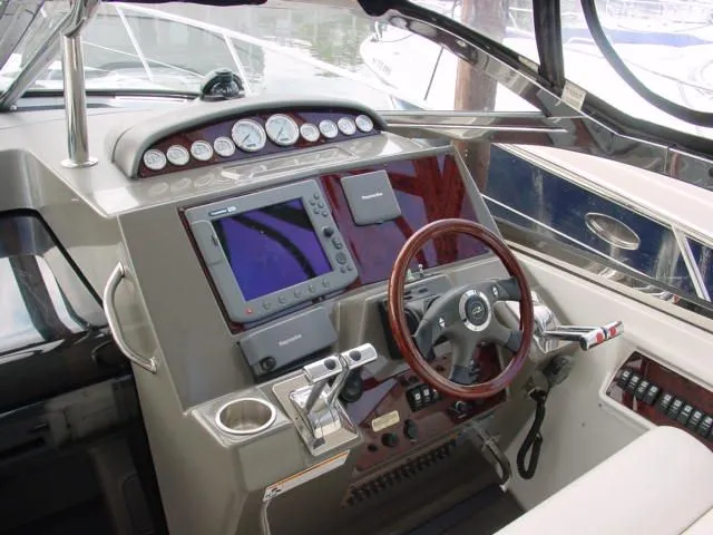 Slide: The Image of 2007 Regal 4460 Commodore helm with navigation instruments and wooden steering wheel. - 9