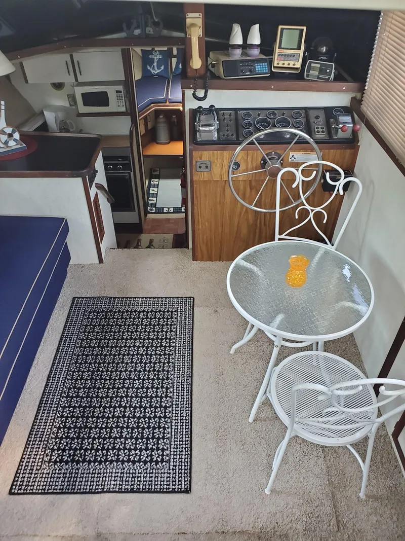 Slide: The Image of Interior of 1983 Carver 3207 AFT Cabin Motor Yacht with dining area and control panel. - 13