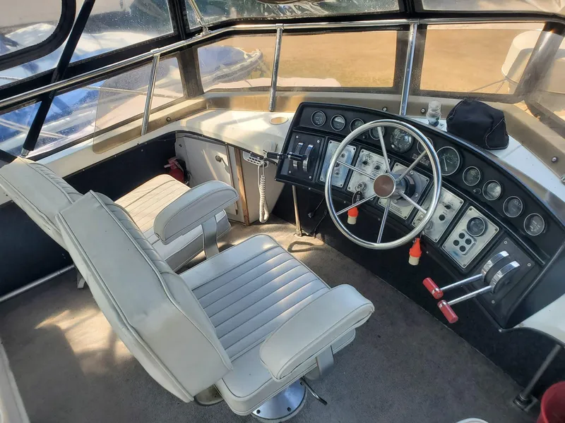 Slide: The Image of 1983 Carver 3207 AFT Cabin Motor Yacht helm with dual seats and control panel. - 18
