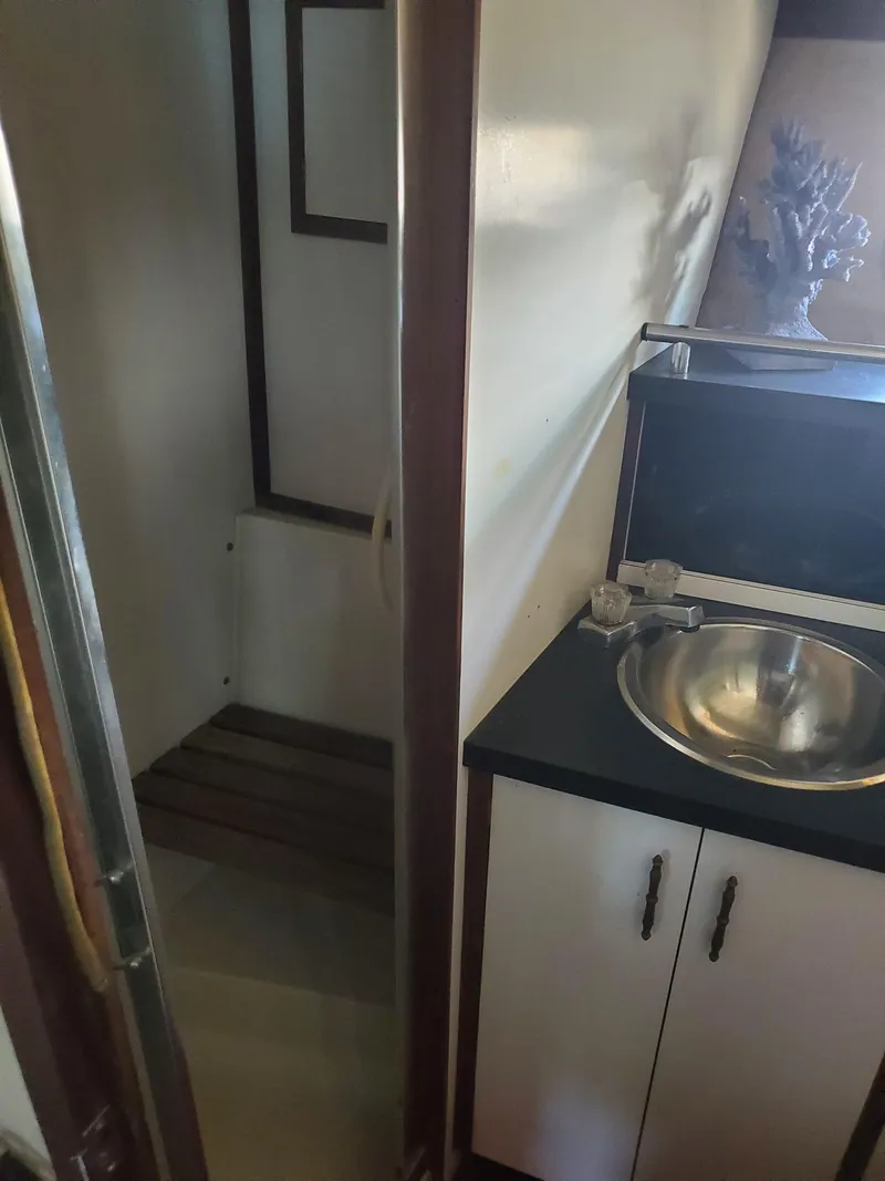 Slide: The Image of 1983 Carver 3207 AFT Cabin Motor Yacht bathroom with sink and shower area. - 19