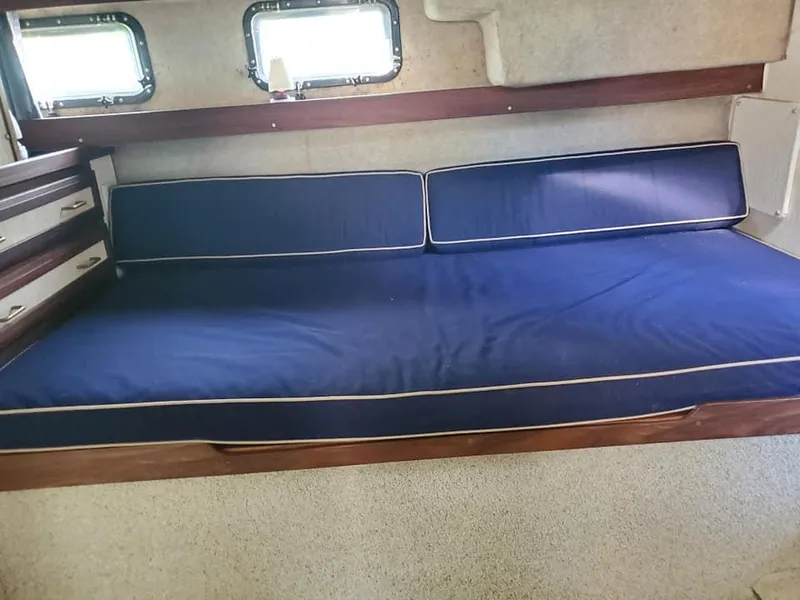 Slide: The Image of 1983 Carver 3207 AFT Cabin Motor Yacht interior with blue cushioned seating. - 21