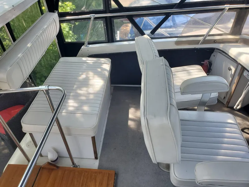 Slide: The Image of Interior of 1983 Carver 3207 AFT Cabin Motor Yacht with white seating and helm area. - 22