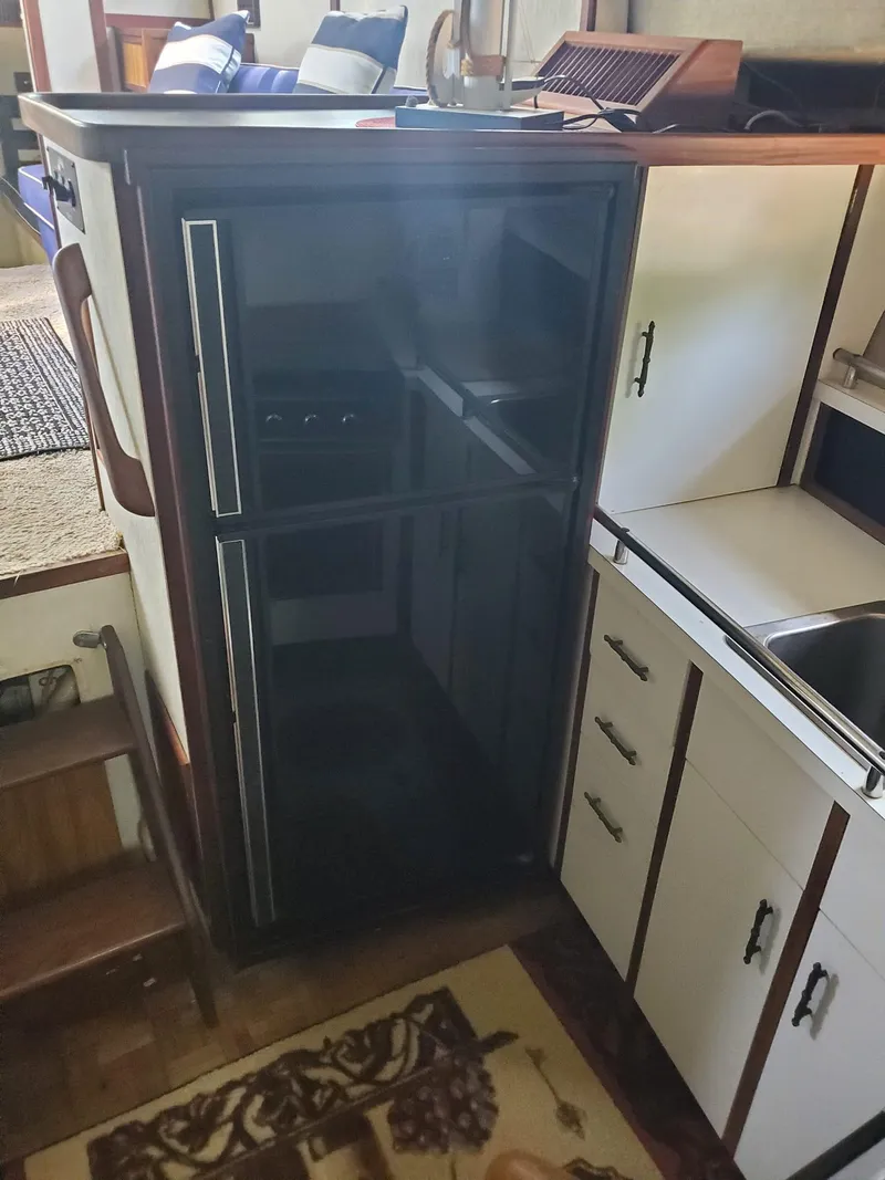 Slide: The Image of 1983 Carver 3207 Aft Cabin Motor Yacht kitchen with fridge and cabinetry. - 10