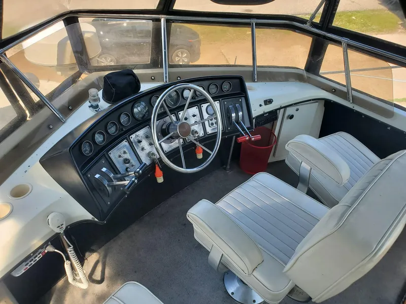 Slide: The Image of 1983 Carver 3207 AFT Cabin Motor Yacht helm with dual seats and control panel. - 14