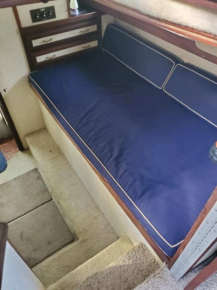 Slide: The Image of Interior of 1983 Carver 3207 AFT Cabin Motor Yacht with blue cushioned seating. - 7