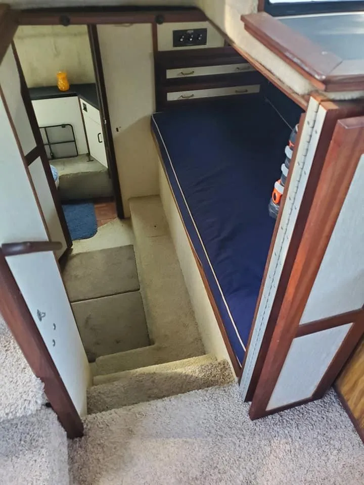 Slide: The Image of 1983 Carver 3207 AFT Cabin Motor Yacht interior with cozy sleeping area and compact design. - 8