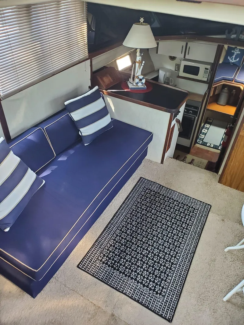 Slide: The Image of Interior of 1983 Carver 3207 AFT Cabin Motor Yacht with blue sofa and nautical decor. - 9