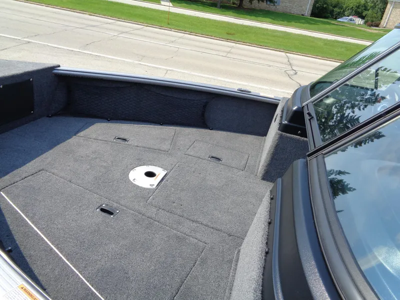 Slide: The Image of 2024 Lund 1875 Impact XS boat interior with spacious deck and storage compartments. - 4