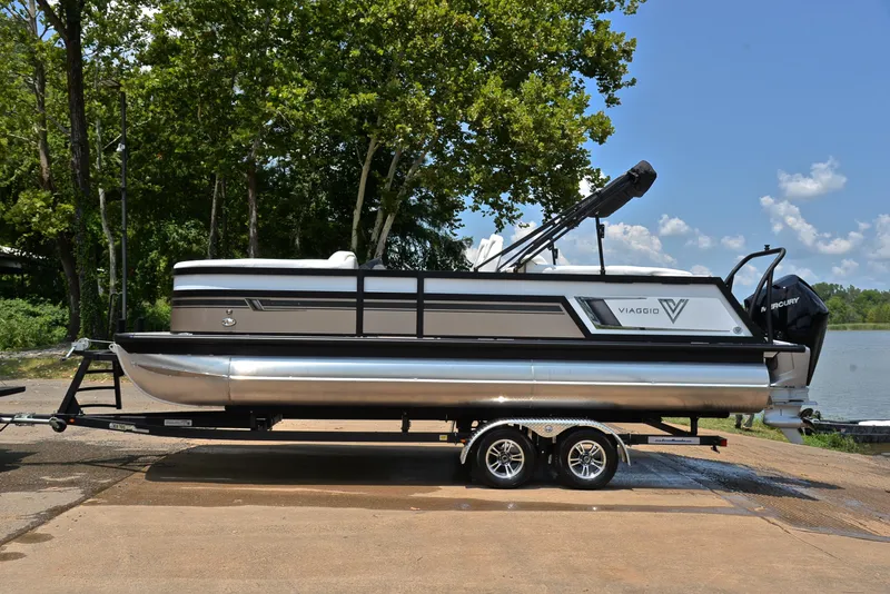 Slide: The Image of 2023 Viaggio Diamante 23 U Platinum pontoon boat on trailer by lake. - 11