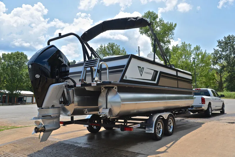 Slide: The Image of 2023 Viaggio Diamante 23 U Platinum pontoon boat on trailer, parked outdoors. - 14