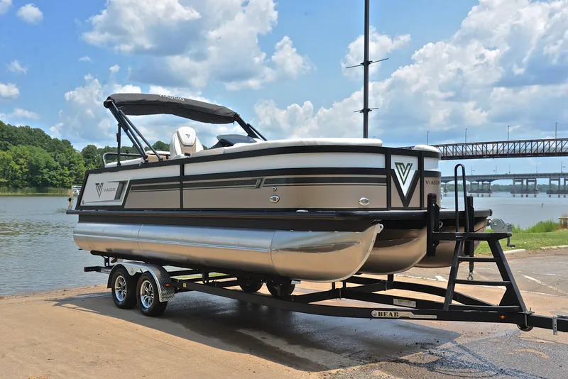 Slide: The Image of 2023 Viaggio Diamante 23 U Platinum pontoon boat on trailer by a lake. - 16