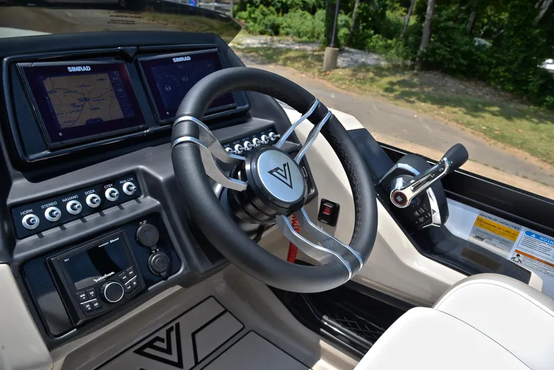 Slide: The Image of 2023 Viaggio Diamante 23 U Platinum boat dashboard with steering wheel and controls. - 26