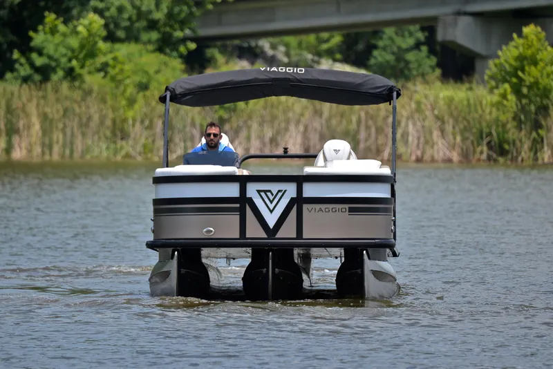Slide: The Image of 2023 Viaggio Diamante 23 U Platinum pontoon boat on a serene lake. - 8