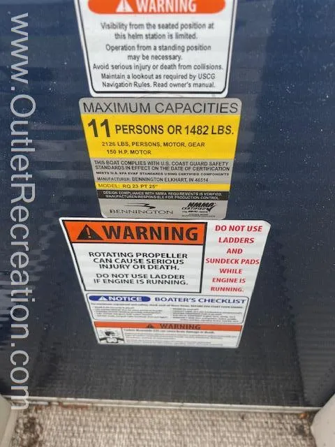 Slide: The Image of Warning labels on a 2017 Bennington 23 RSR boat, indicating capacity and safety instructions. - 19