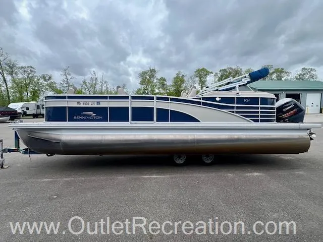Slide: The Image of 2017 Bennington 23 RSR pontoon boat on trailer, blue and white design. - 6