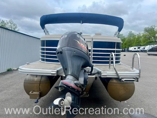 Slide: The Image of 2017 Bennington 23 RSR pontoon boat with Yamaha outboard motor, parked outdoors. - 8