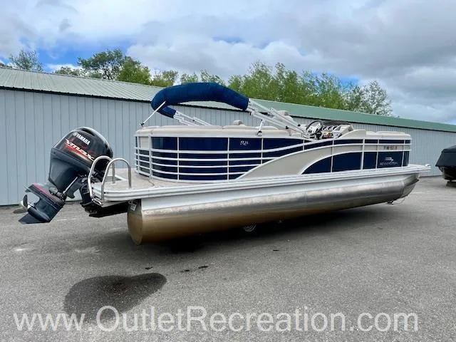 Slide: The Image of 2017 Bennington 23 RSR pontoon boat with Yamaha outboard motor, parked outdoors. - 9