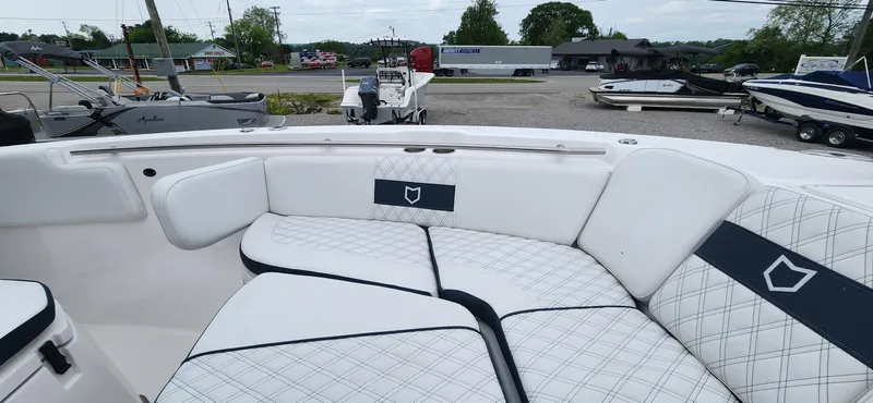 Slide: The Image of 2025 Sea Fox 288 Commander boat with white cushioned seating and diamond pattern design. - 16