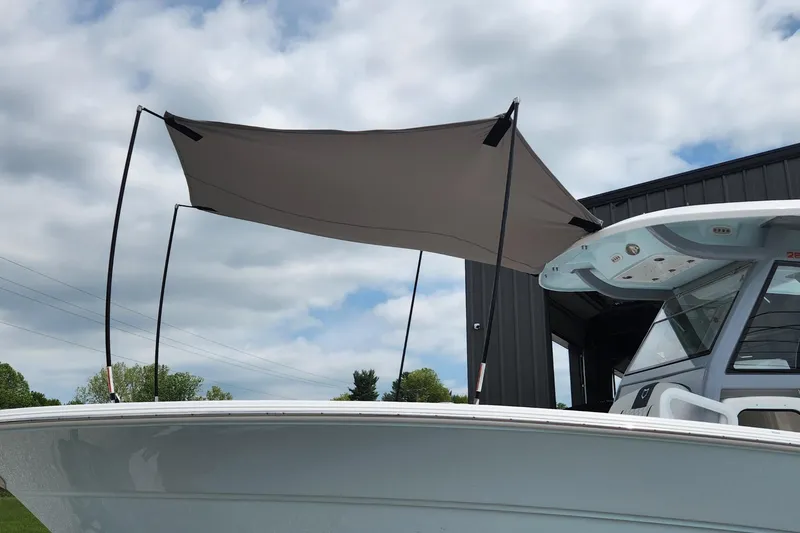 Slide: The Image of 2025 Sea Fox 288 Commander boat with canopy under cloudy sky. - 23