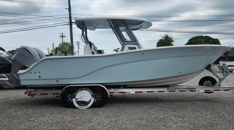 Slide: The Image of 2025 Sea Fox 288 Commander boat on trailer, side view, under cloudy sky. - 3