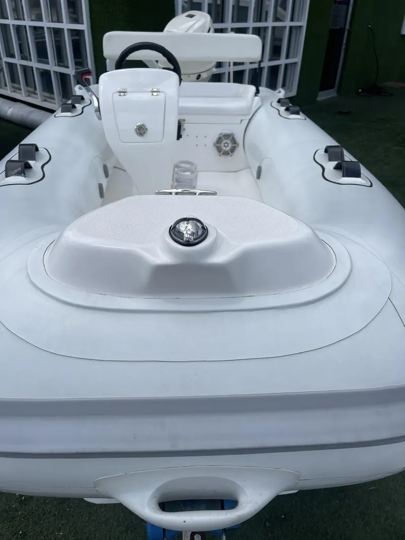 Slide: The Image of White Apex A12 inflatable boat, 2021 model, with steering console and seating. - 11