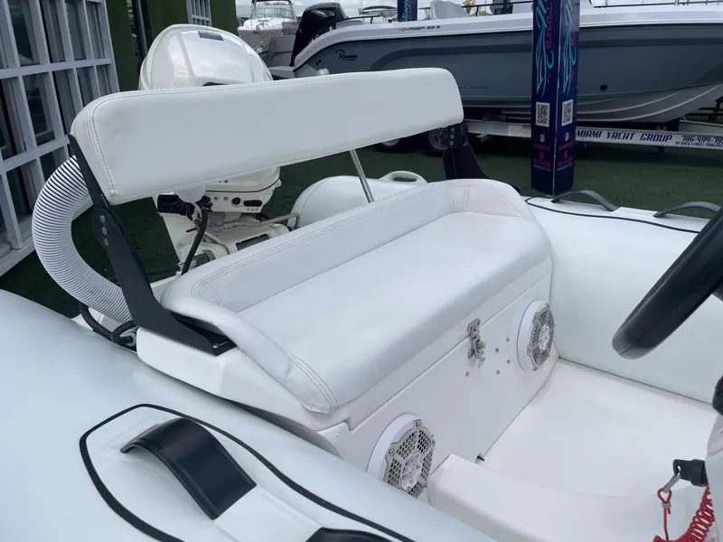 Slide: The Image of White seating area on 2021 Apex A12 boat, featuring speakers and sleek design. - 12